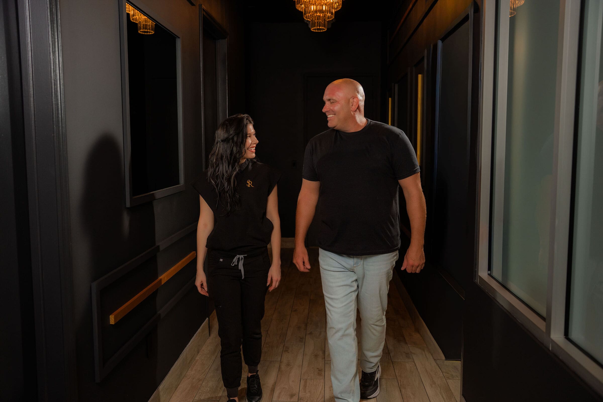 Erica walking a client down the back hall at The Skin Room