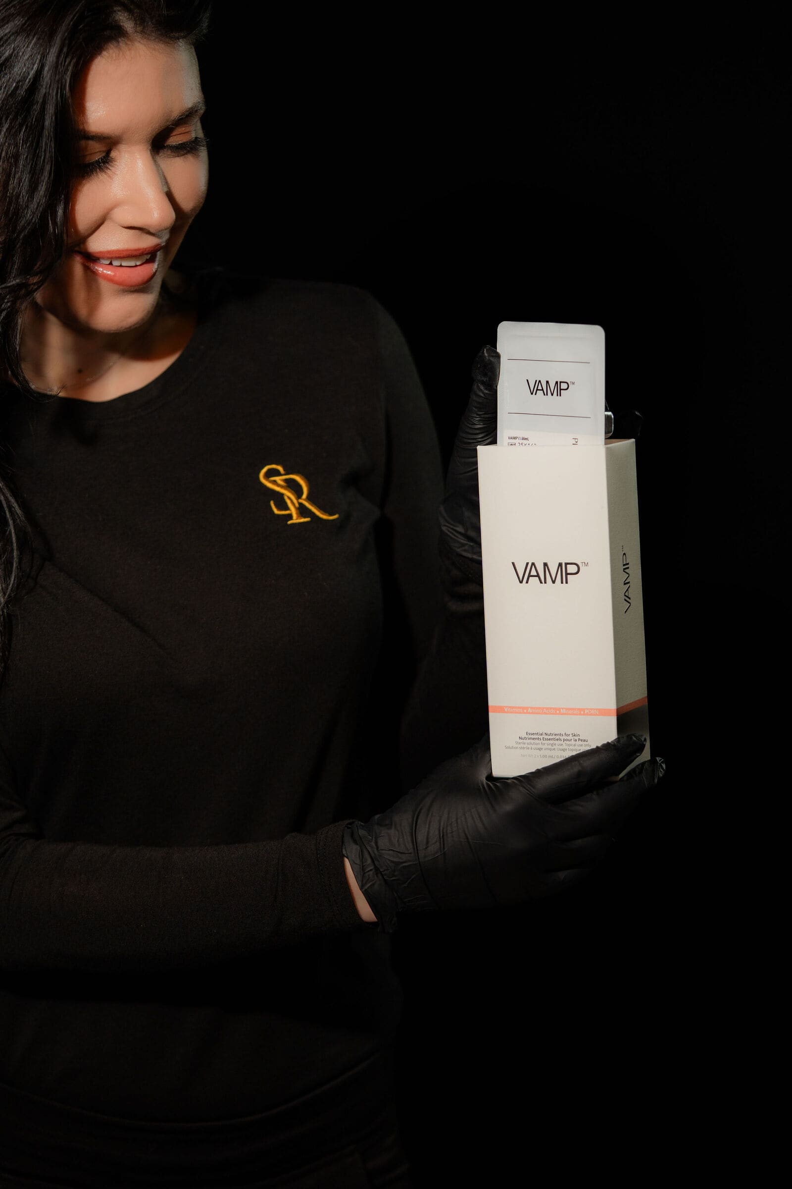 Erica holding a box of VAMP at The Skin Room